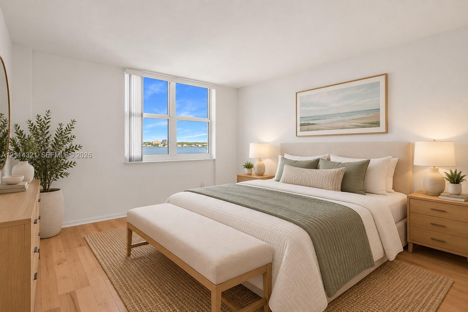 Bedroom featuring large windows, water backdrop, and wood-finish flooring