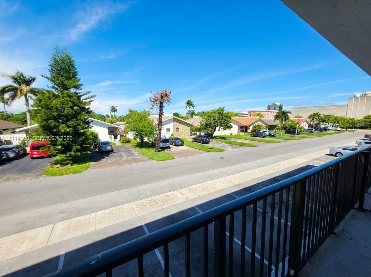 Elevated balcony featuring black metal railings and overhead soffit Elevated balcony featuring black metal railings and overhead soffit