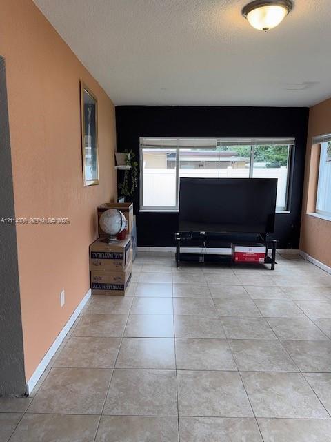 Large-format tile flooring, dual-tone painted walls, and oversized windows