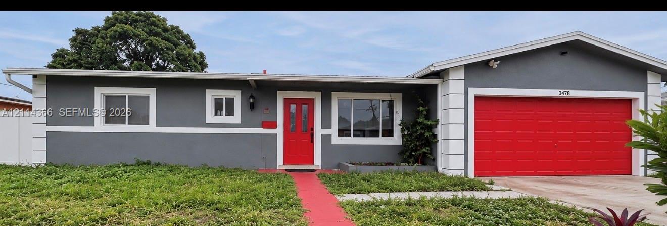 Single-story exterior featuring a gray stucco facade, white corner quoins, red front door, red concrete walkway, and attached two-car garage