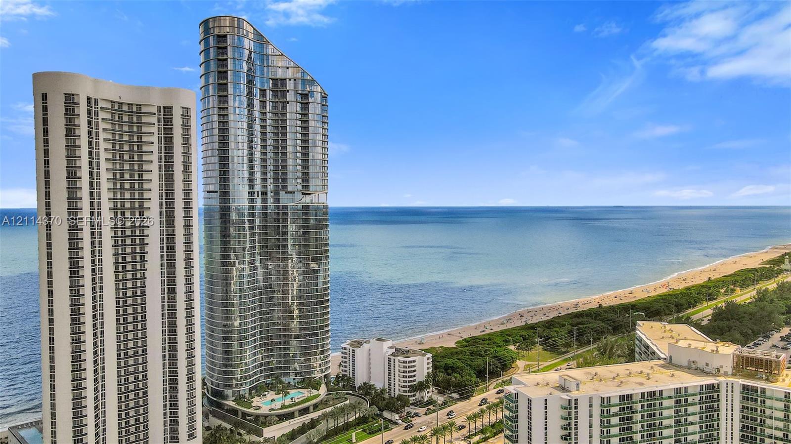 High-rise exterior with glass curtain wall facade, expansive ocean frontage, and integrated swimming pool