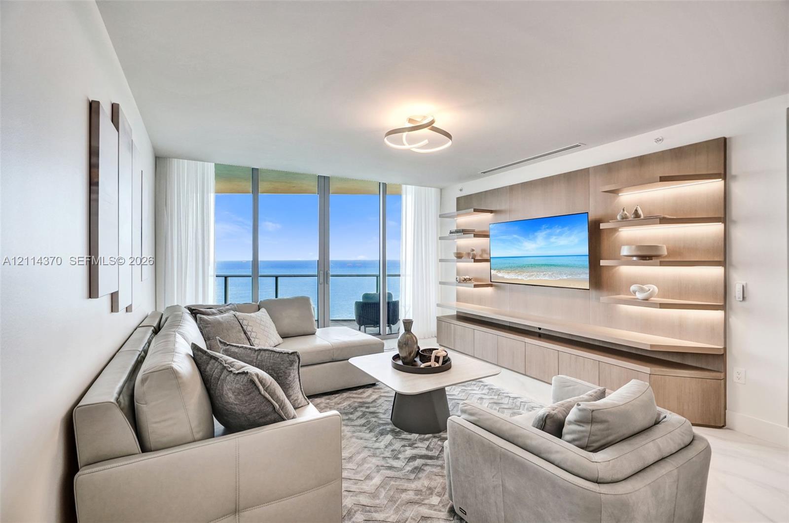 Floor-to-ceiling glass windows, custom built-in wood cabinetry with integrated accent lighting, floating display shelving, and light-tone flooring