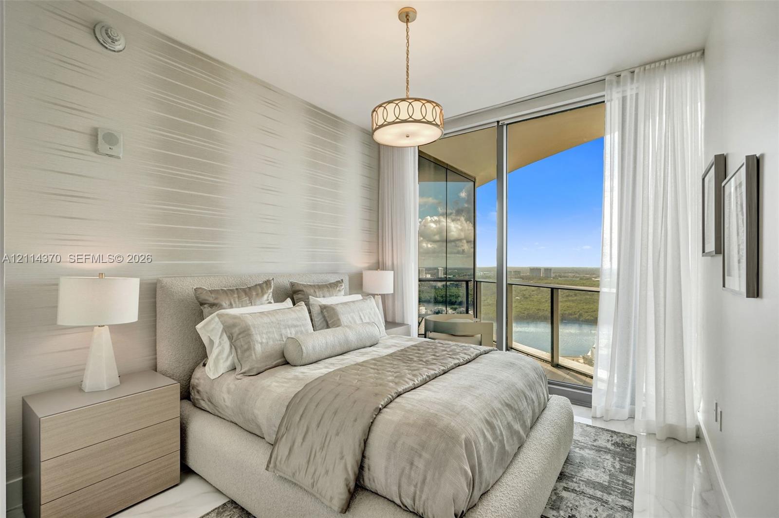 Floor-to-ceiling glass paneling, polished stone flooring, textured wall covering, and a contemporary drum pendant light fixture, with access to a private balcony