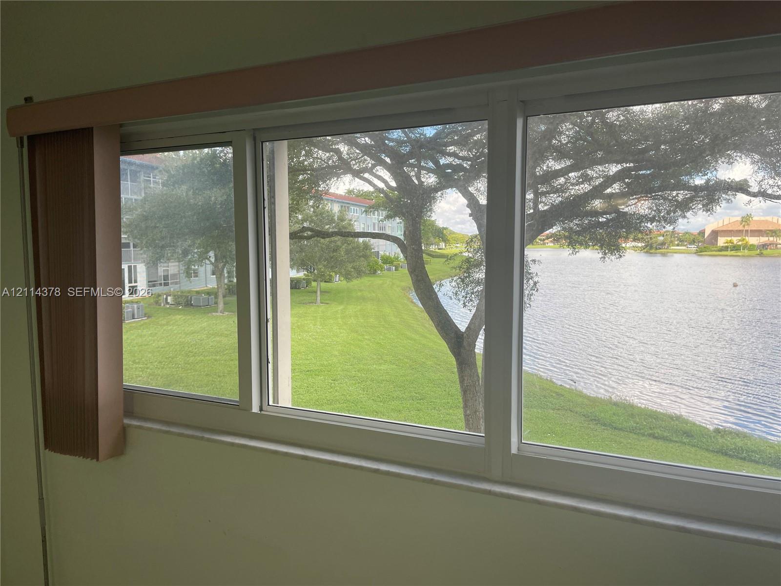 Large horizontal multi-pane windows with white framing, including a stone-finish sill