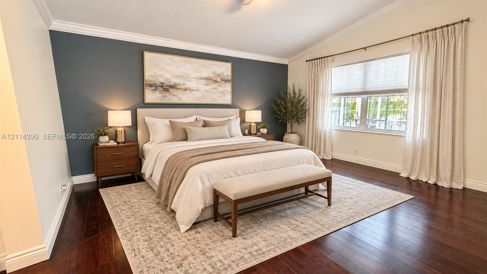 Vaulted ceiling with crown molding, dark wood-finish flooring, and large window with multi-panel casing