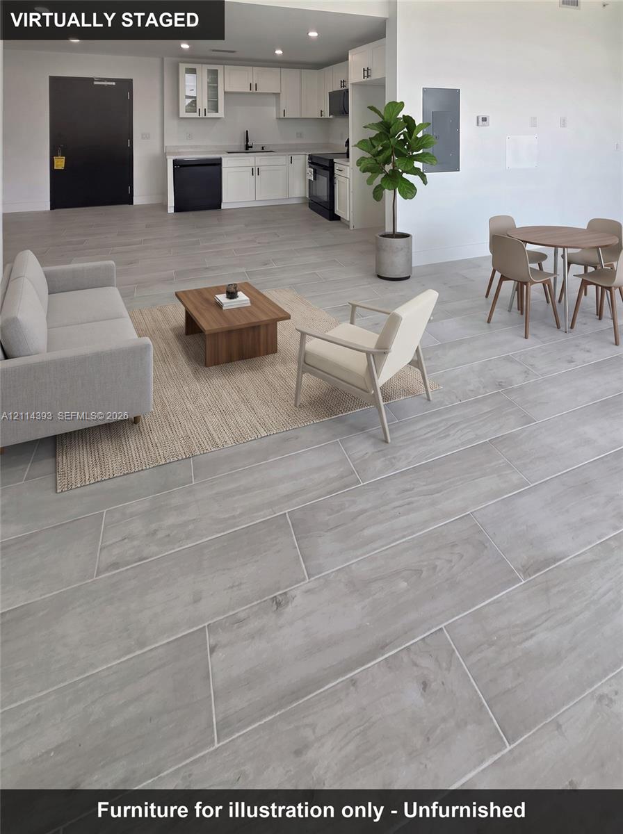 Kitchen featuring white shaker-style cabinetry, recessed ceiling lighting, and porcelain tile flooring with a wood-finish aesthetic