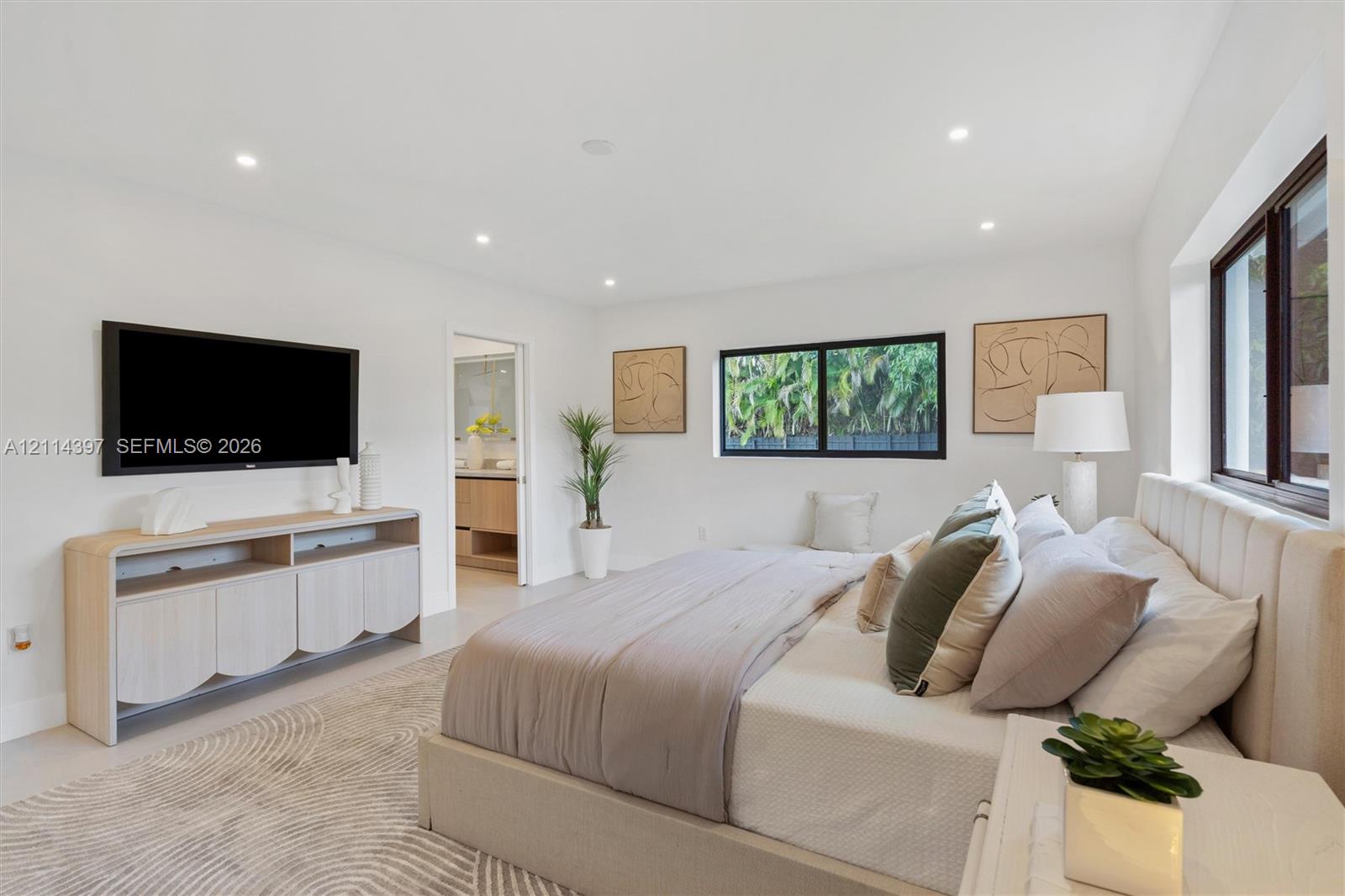 Spacious room featuring neutral paint, recessed lighting, polished tile flooring, and dark-framed windows