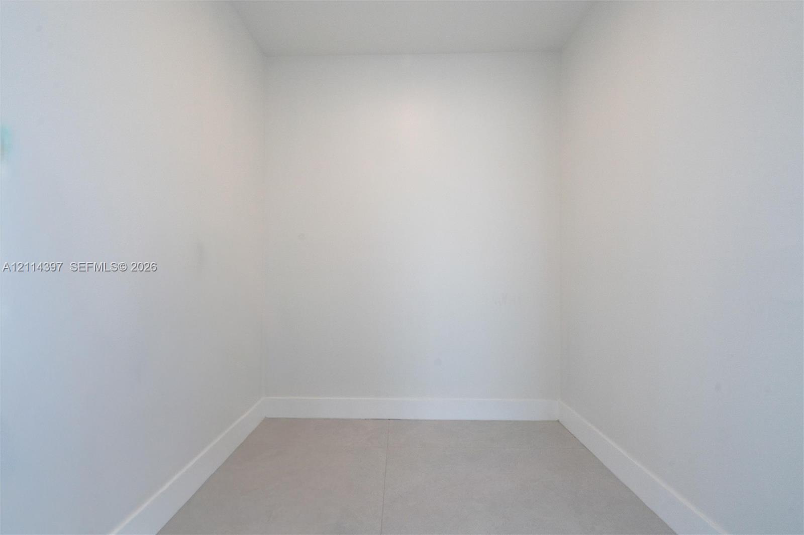 Interior space featuring neutral wall tones and large-format tile flooring