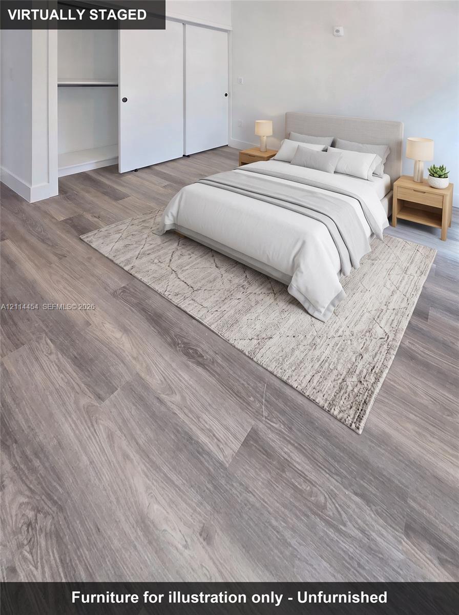 Neutral-toned wood-finish flooring and sliding-door closet with shelving