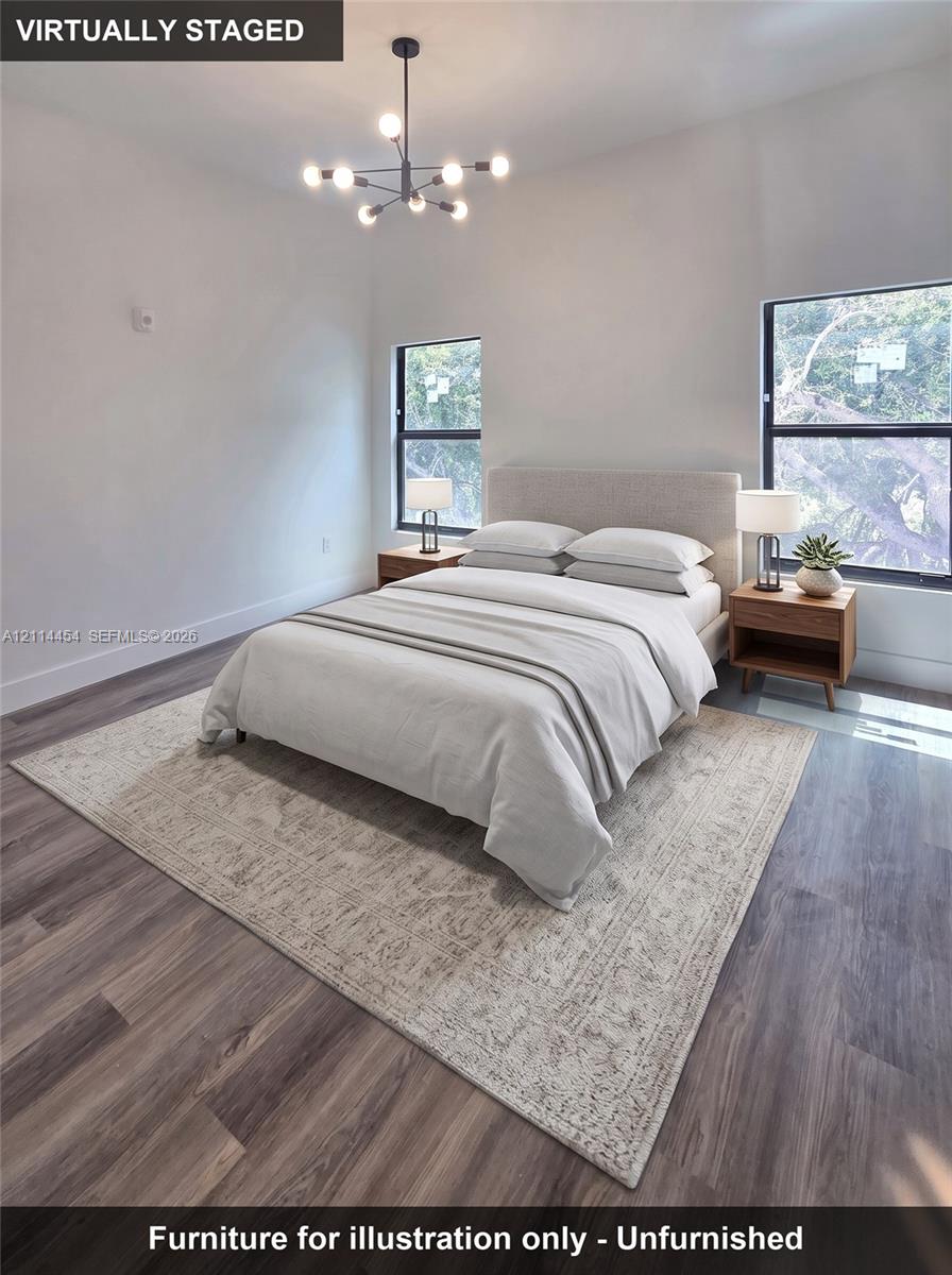 Wood-finish flooring, multi-arm geometric light fixture, and dual windows with black frames