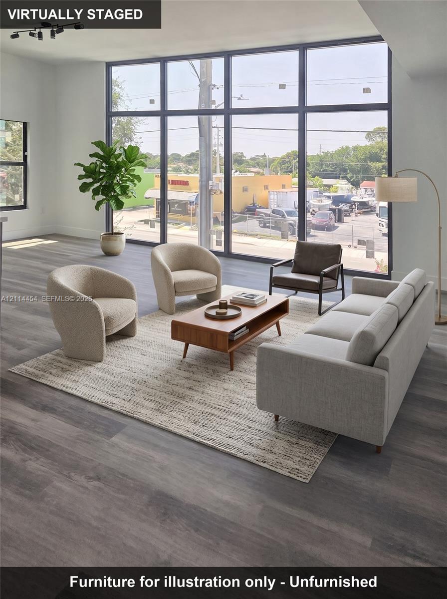Floor-to-ceiling windows with black framing, wood-finish flooring, and recessed ceiling lighting