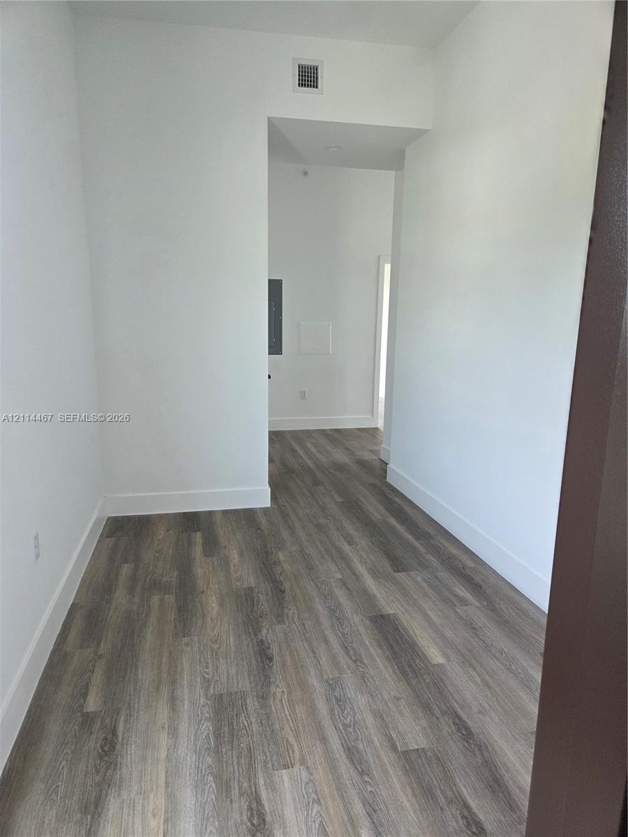 Neutral wall finishes featuring wood-finish flooring