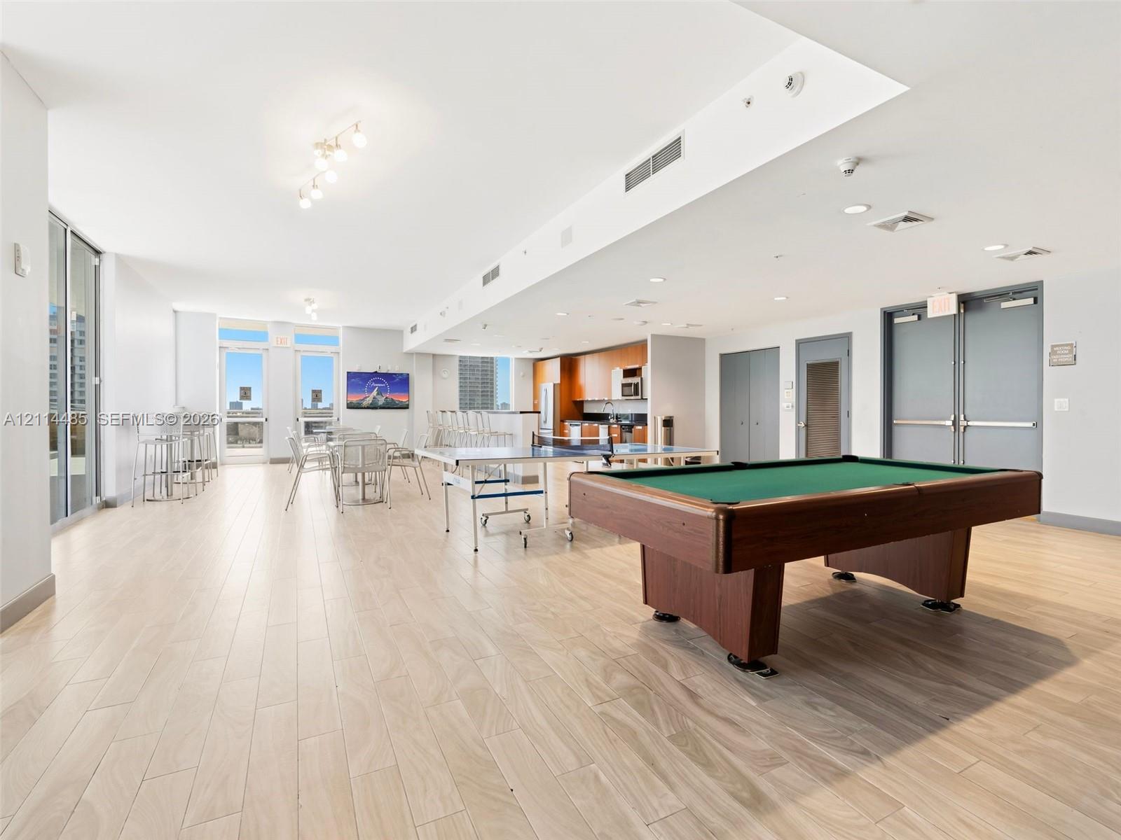 Open-concept floor plan featuring wood-finish flooring, recessed lighting, and expansive floor-to-ceiling glass doors