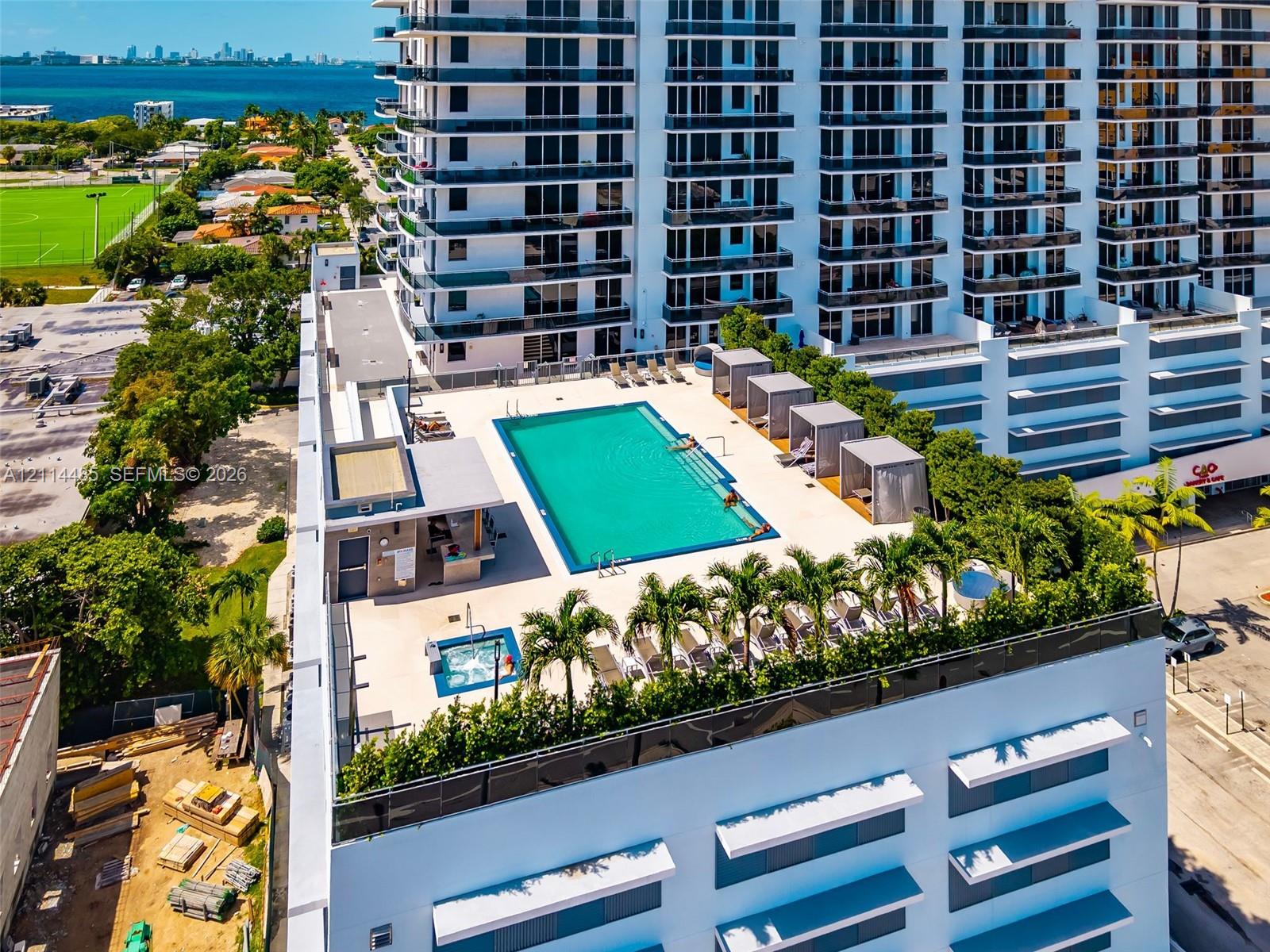 Rooftop terrace featuring a swimming pool, integrated spa, built-in outdoor bar, and a landscaped perimeter