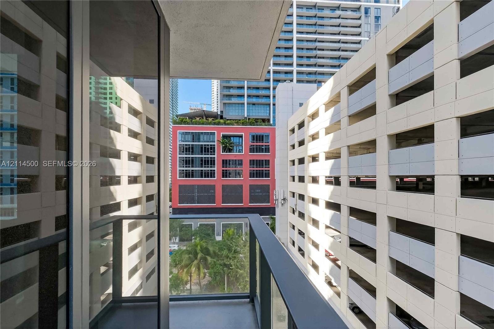 Private balcony featuring glass panel railings and metal framing