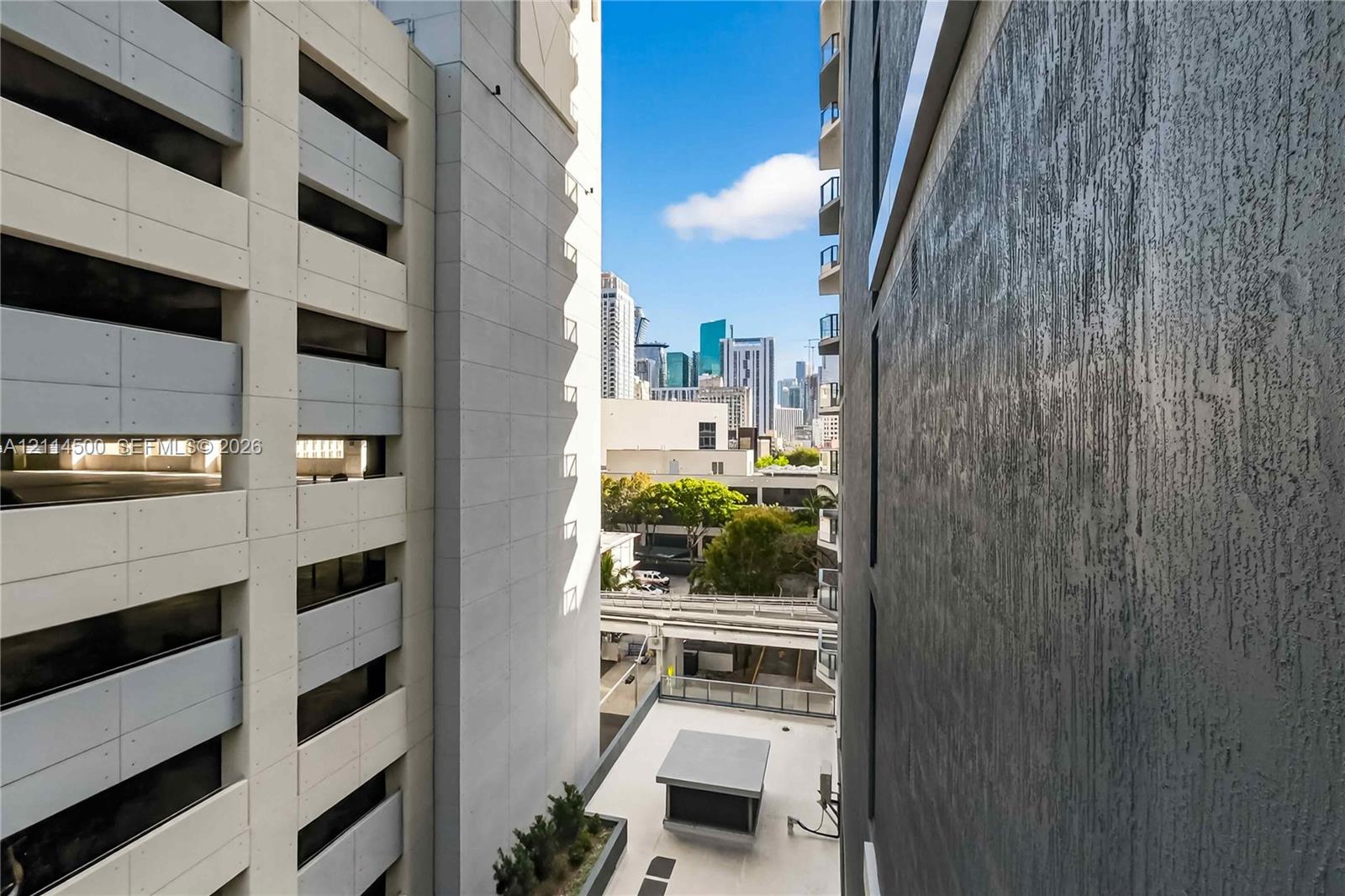 Urban skyline landscape featuring textured charcoal-colored exterior siding, light-toned concrete structural facade, and tiered high-rise architecture