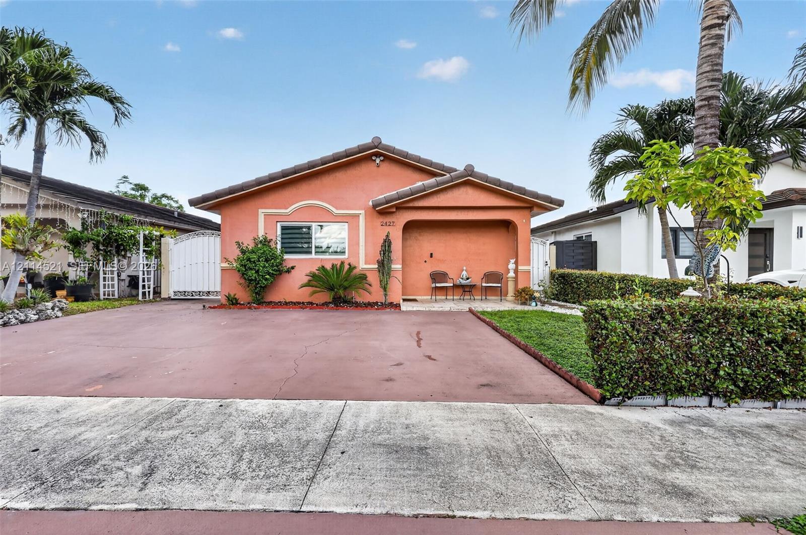 Single-story residence featuring a tile roof, stucco exterior, covered entryway, and a paved driveway Single-story residence featuring a tile roof, stucco exterior, covered entryway, and a paved driveway