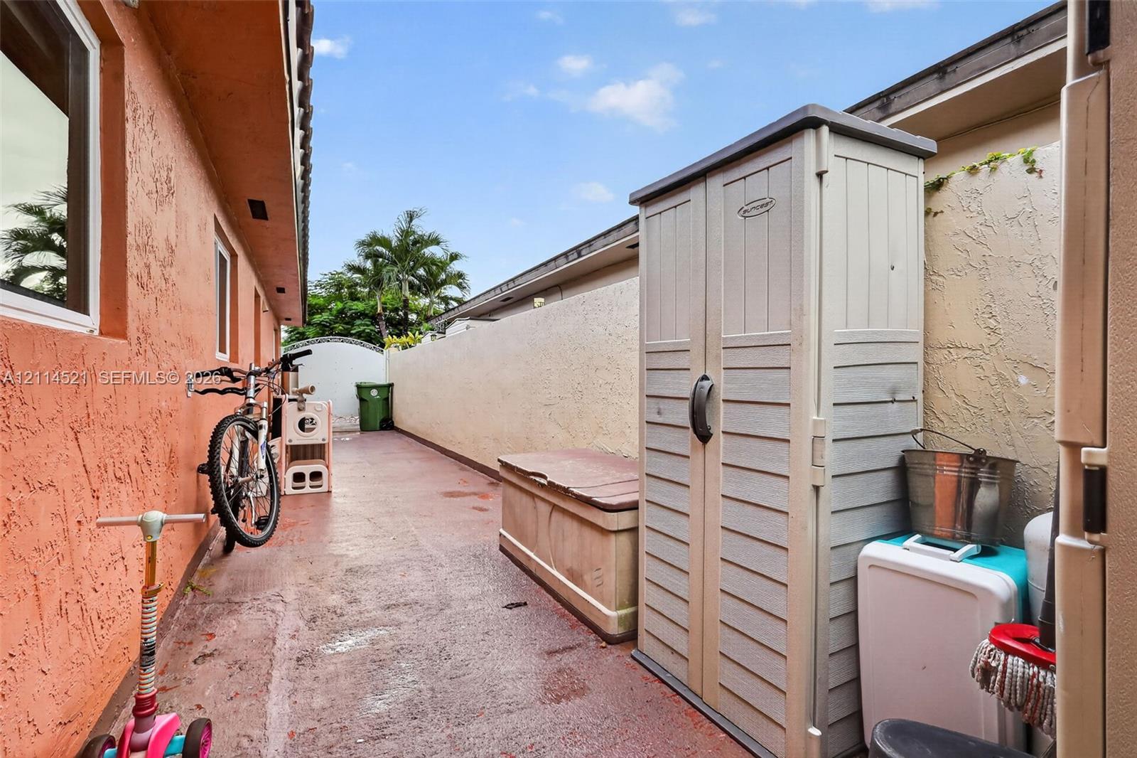 Side yard featuring a concrete patio surface and stucco wall enclosure