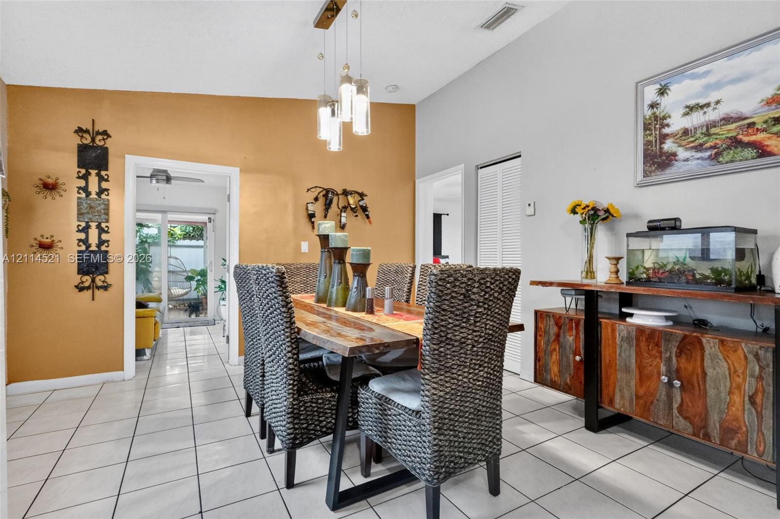 Vaulted ceilings, pendant lighting, ceramic tile flooring, and louvered closet doors