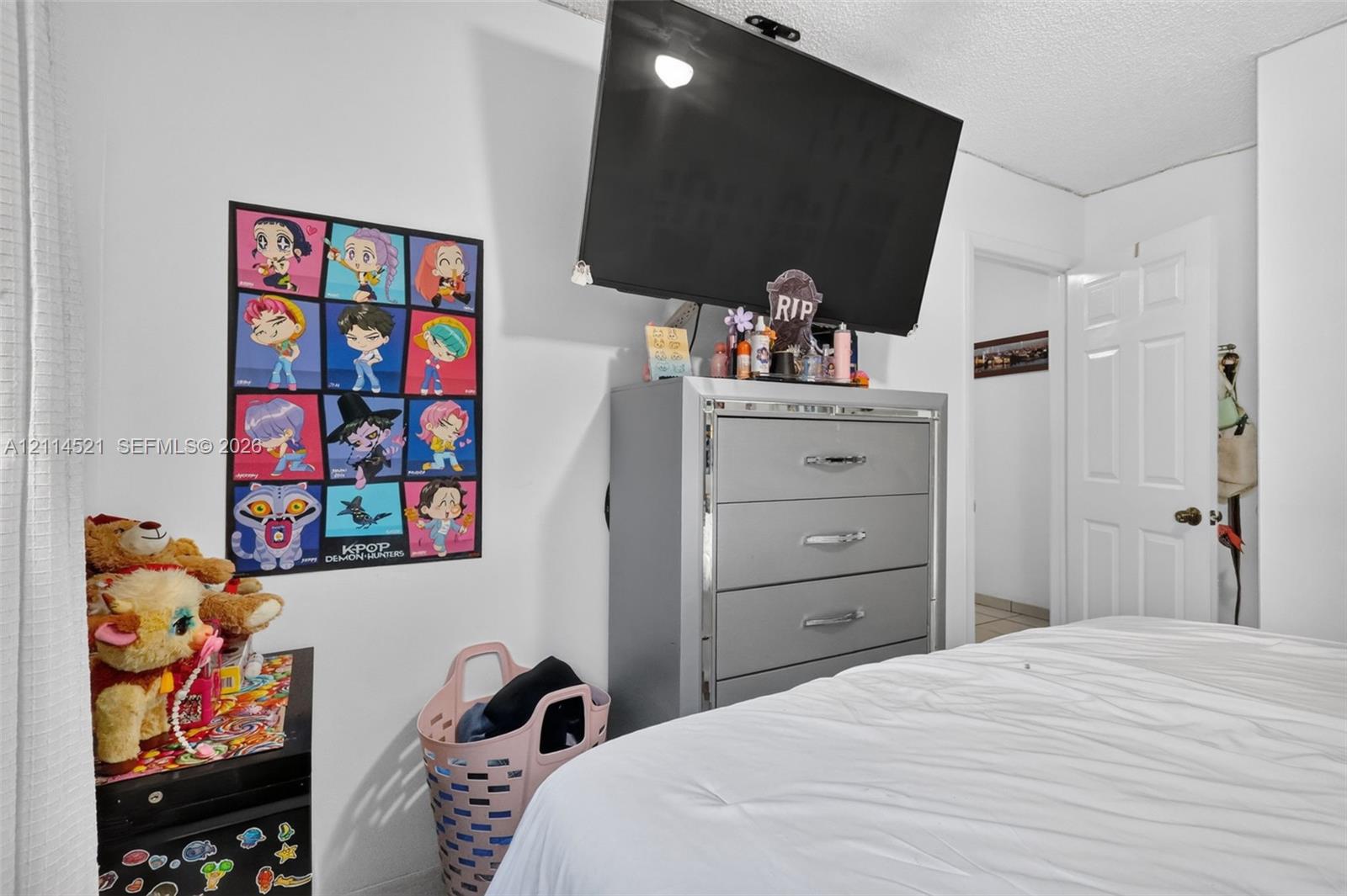 Interior room featuring a textured ceiling and a six-panel door