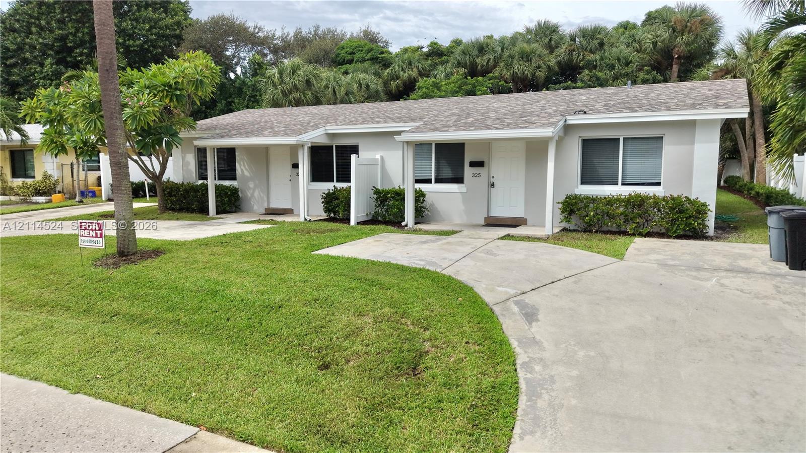Single-story building exterior featuring a low-slope roof, concrete driveway, and manicured landscaping Single-story building exterior featuring a low-slope roof, concrete driveway, and manicured landscaping