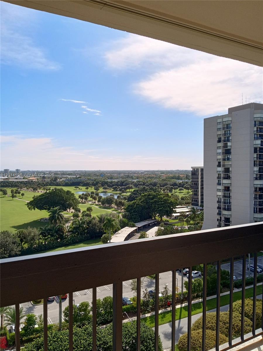 Elevated balcony featuring a metal railing with a panoramic outlook of the surrounding landscape and green space