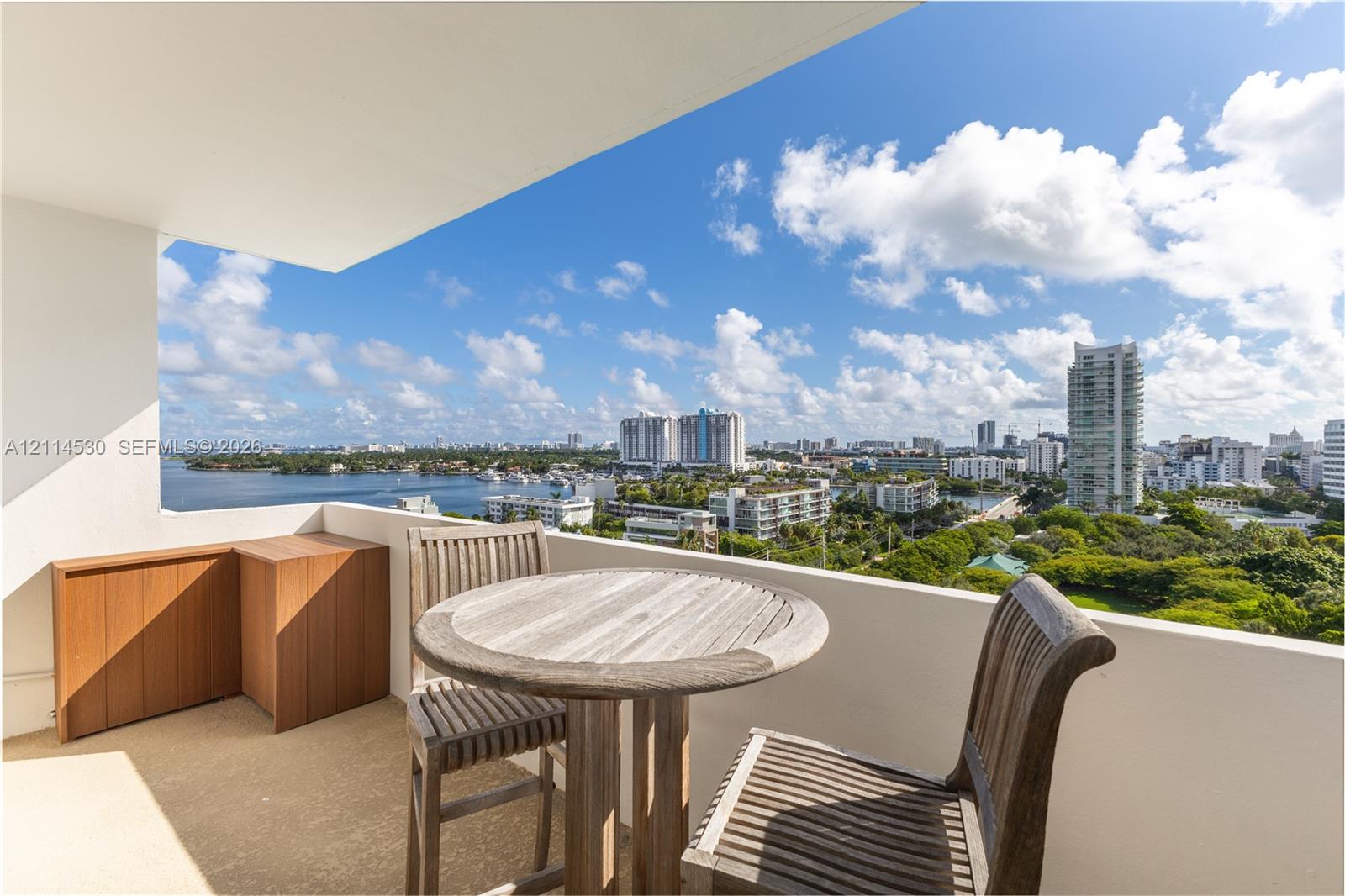 Private balcony with solid half-wall enclosure and built-in wood cabinetry
