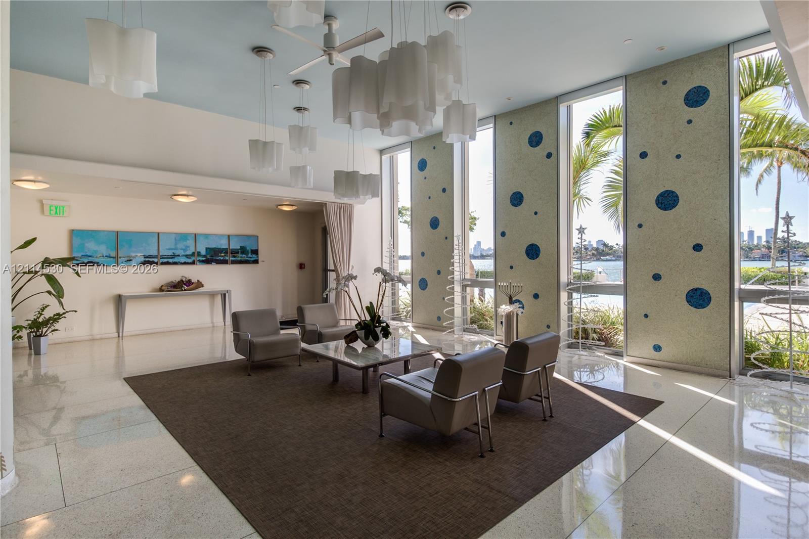 Polished stone flooring, floor-to-ceiling windows, decorative custom mosaic wall panels, and tiered pendant lighting fixtures