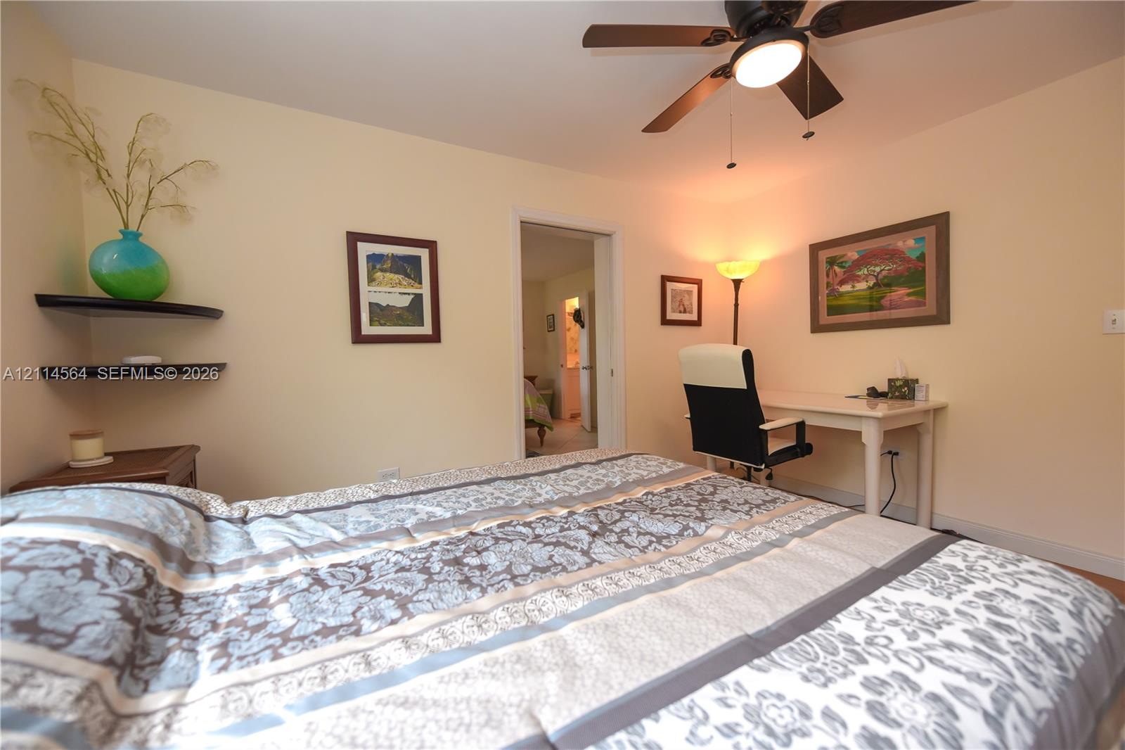 Room featuring a ceiling fan with integrated lighting and two floating wall shelves