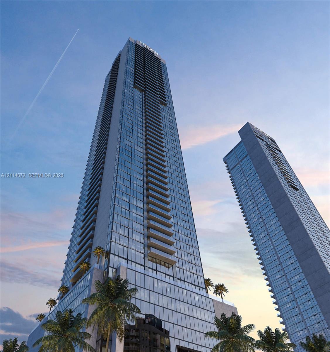 High-rise glass facade featuring floor-to-ceiling windows, private recessed balconies, and integrated terrace-level landscaping