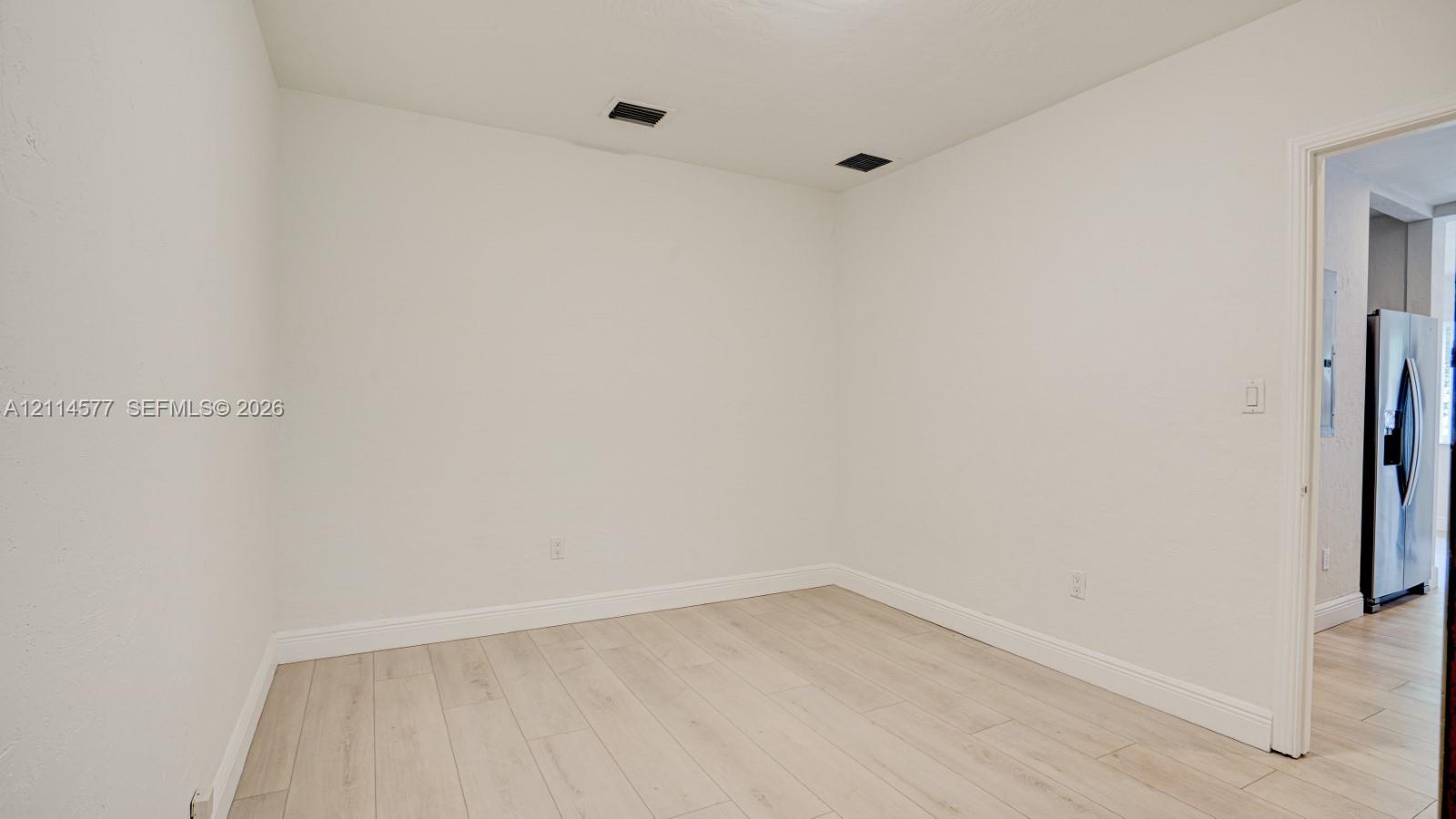 Interior space featuring wood-finish tile flooring and neutral wall paint