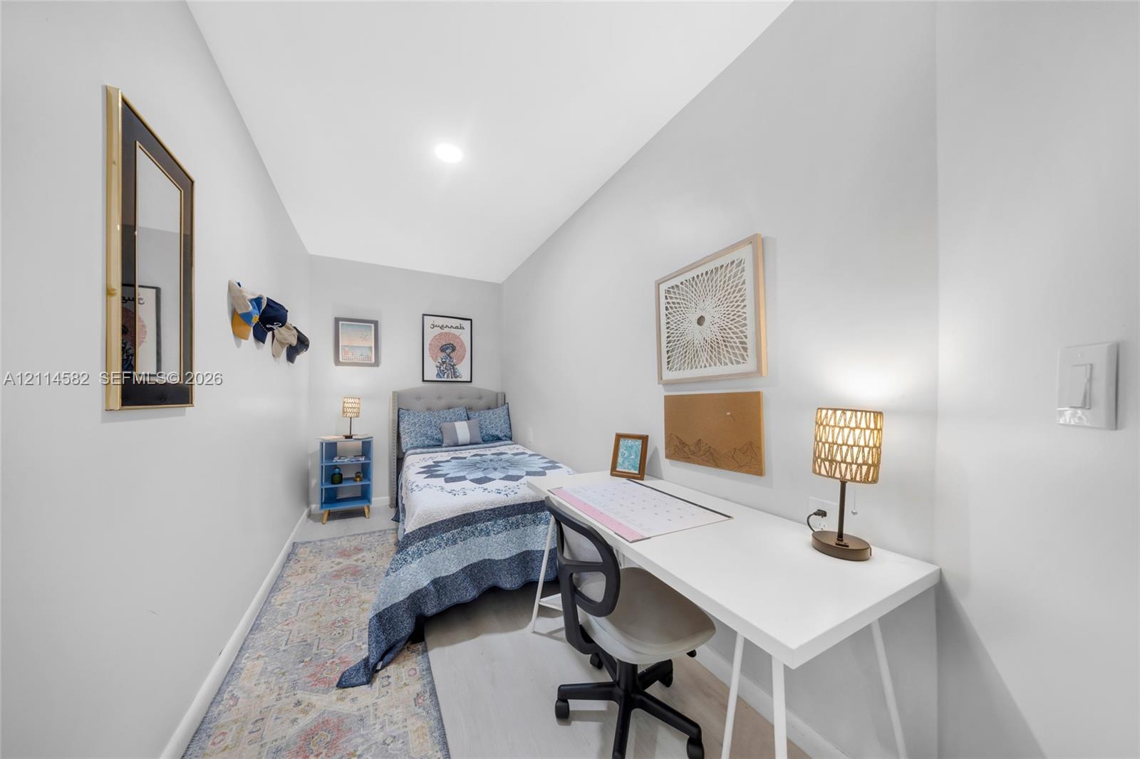 Neutral wall finishes, recessed lighting, and wood-finish flooring
