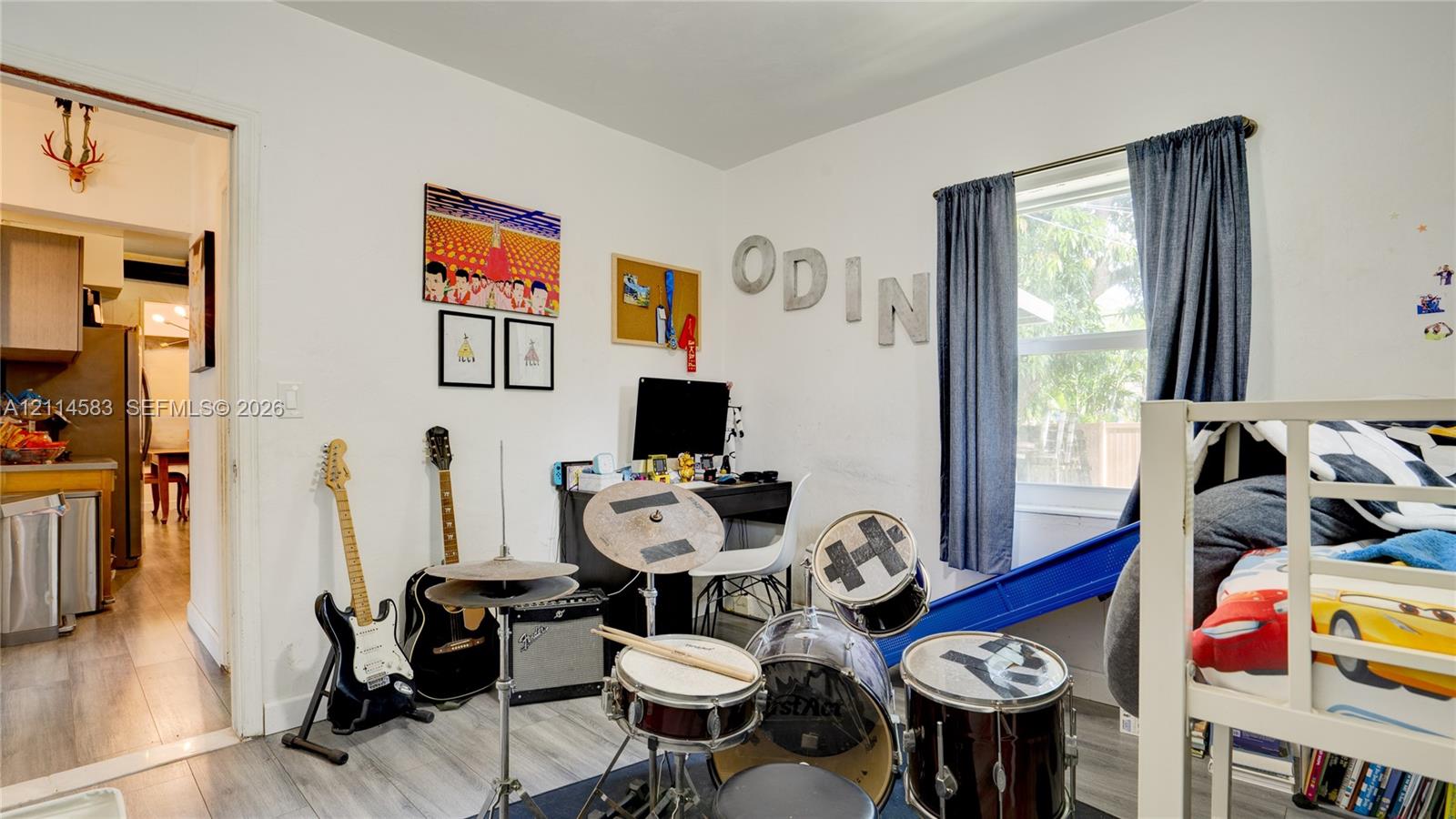 Room featuring neutral wall finishes, wood-finish flooring, and a single-pane window