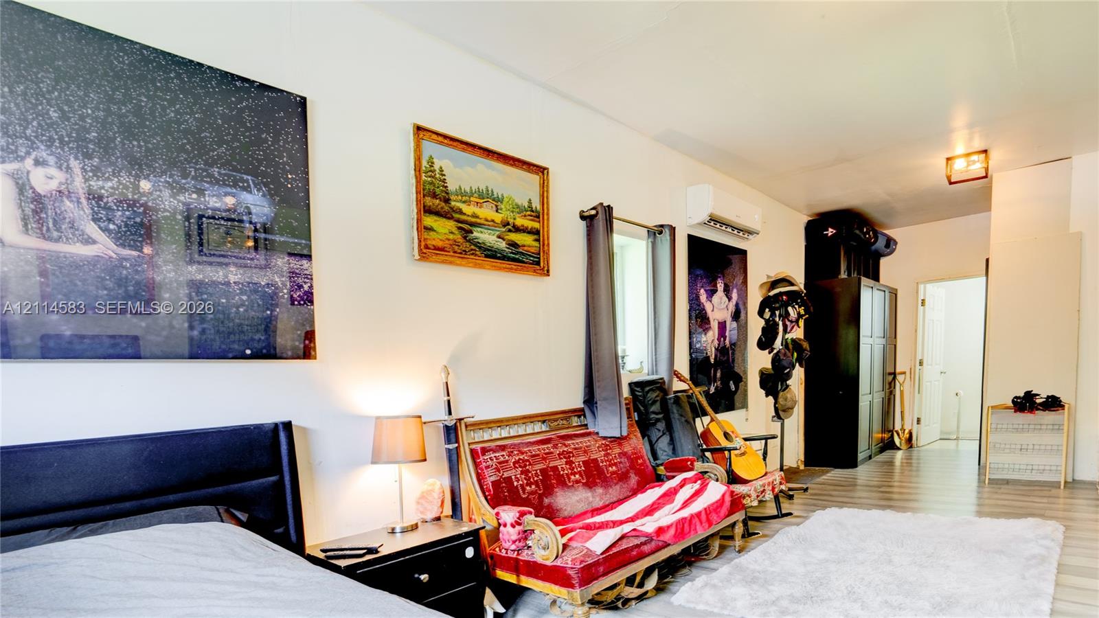 Wood-finish flooring, wall-mounted climate control unit, and recessed ceiling lighting