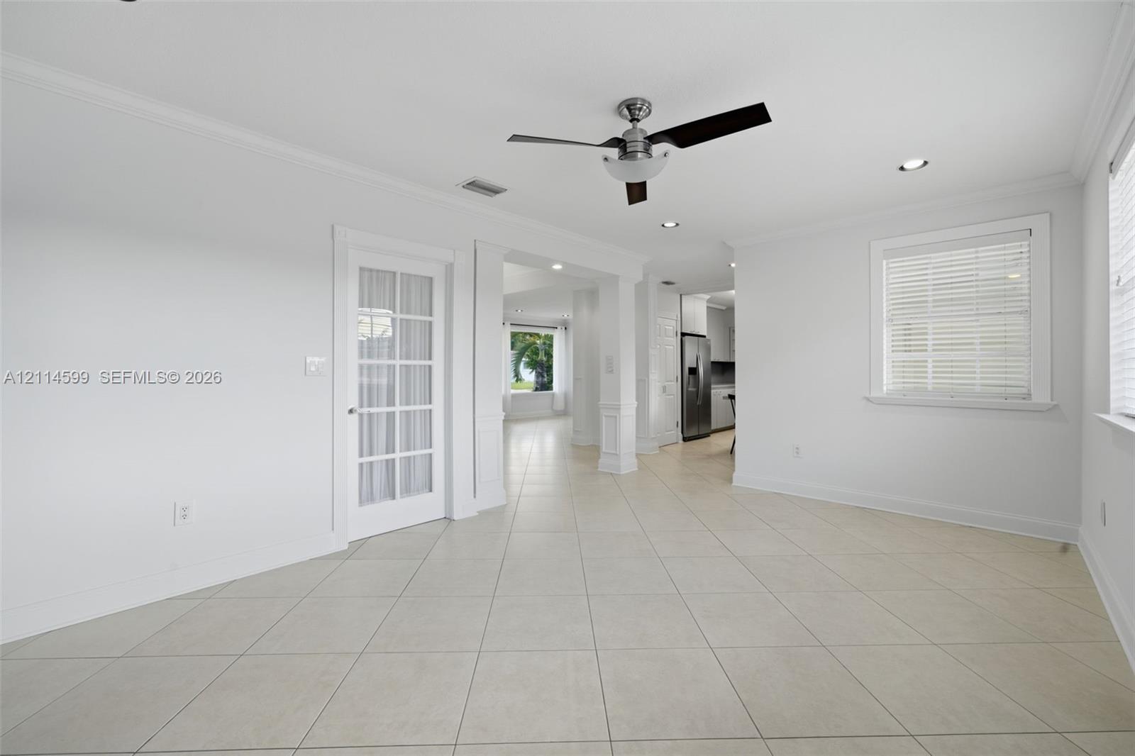 Ceramic tile flooring, recessed lighting, ceiling fan, and multi-pane glass door