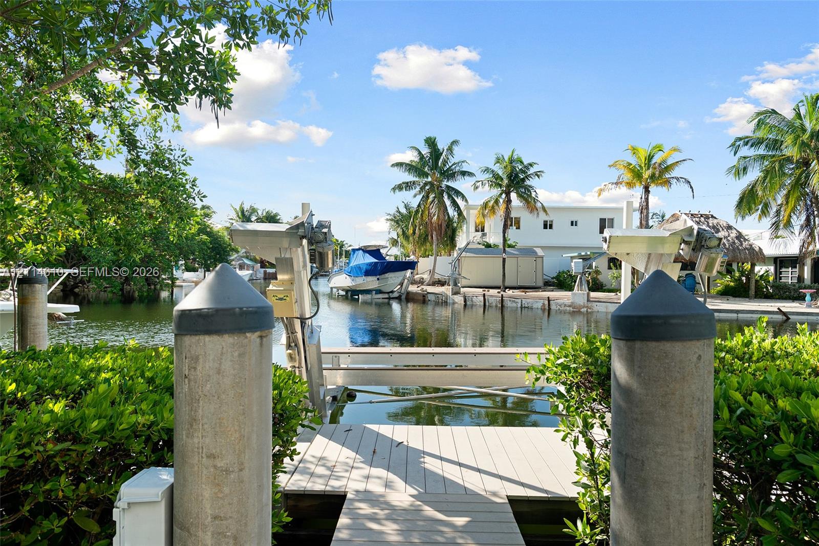 Waterfront dock featuring composite decking, reinforced concrete pilings, and an integrated boat lift system