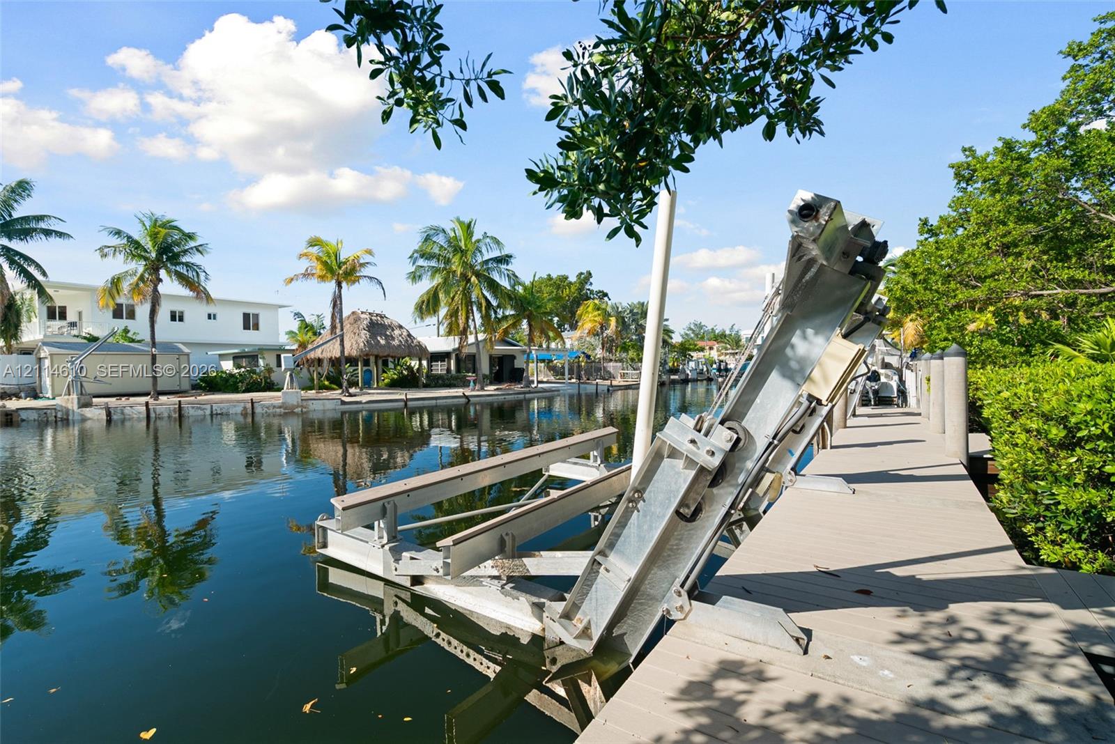 Waterfront bulkhead with a dedicated boat lift and a composite plank dock