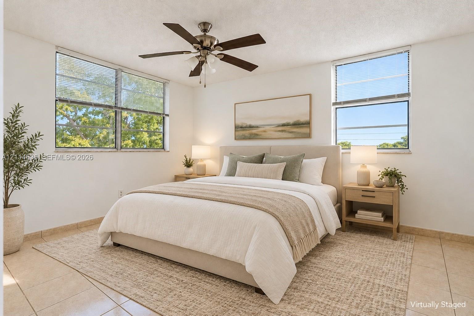 Neutral-toned tile flooring, multi-pane windows, and a multi-blade ceiling fan with integrated lighting