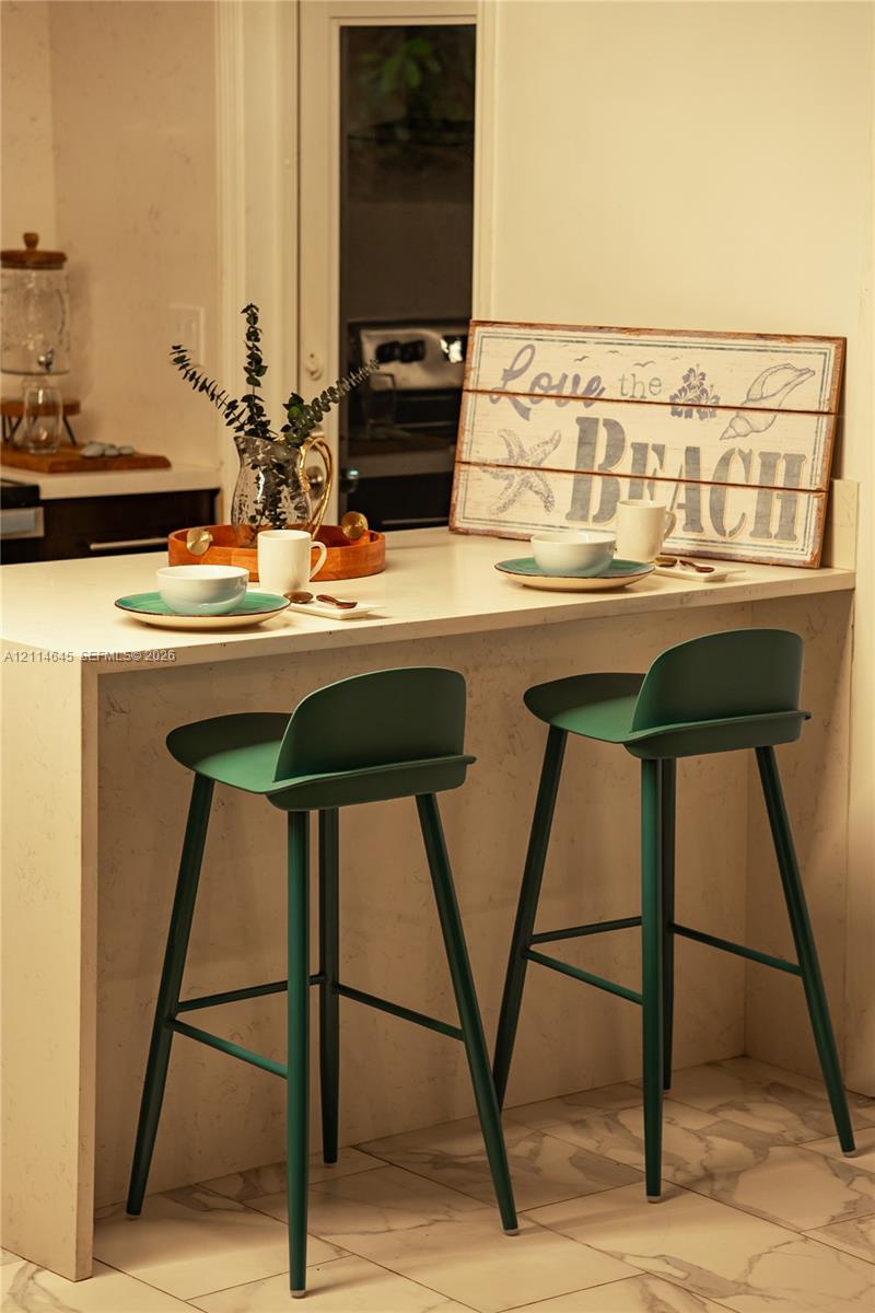 Countertop with waterfall edge, integrated flat-surface finish, and tile flooring