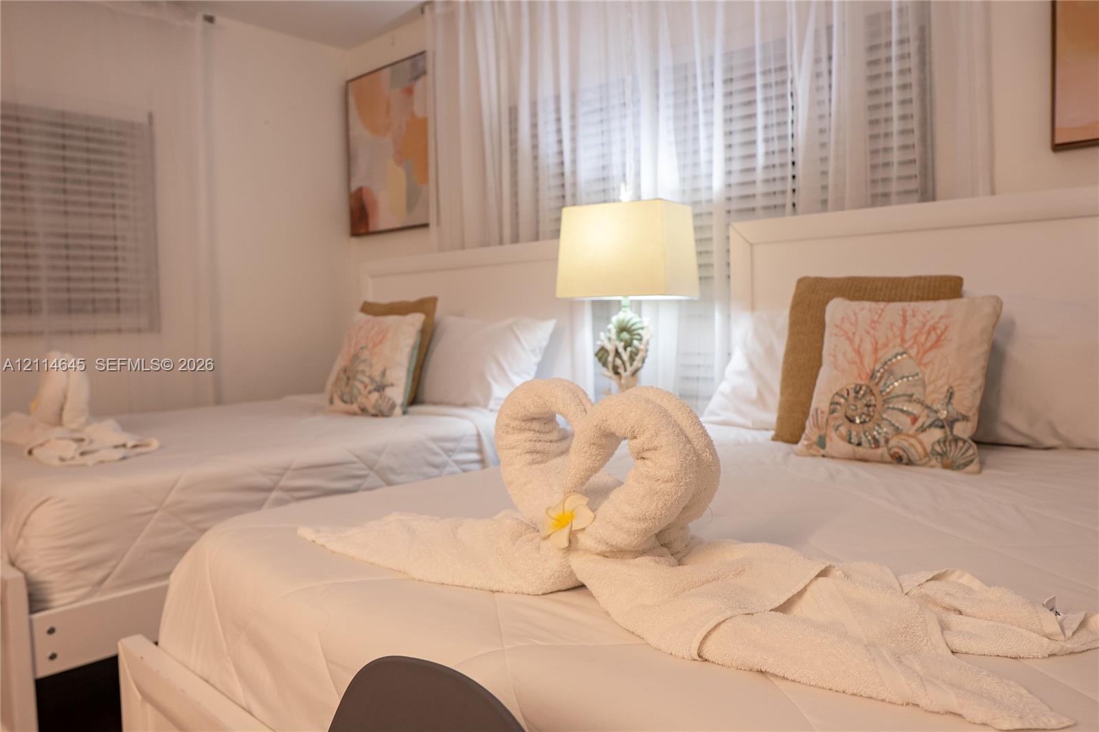 Room featuring horizontal window blinds and sheer window treatments