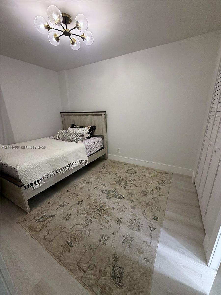 Neutral interior featuring light wood-finish flooring and white walls