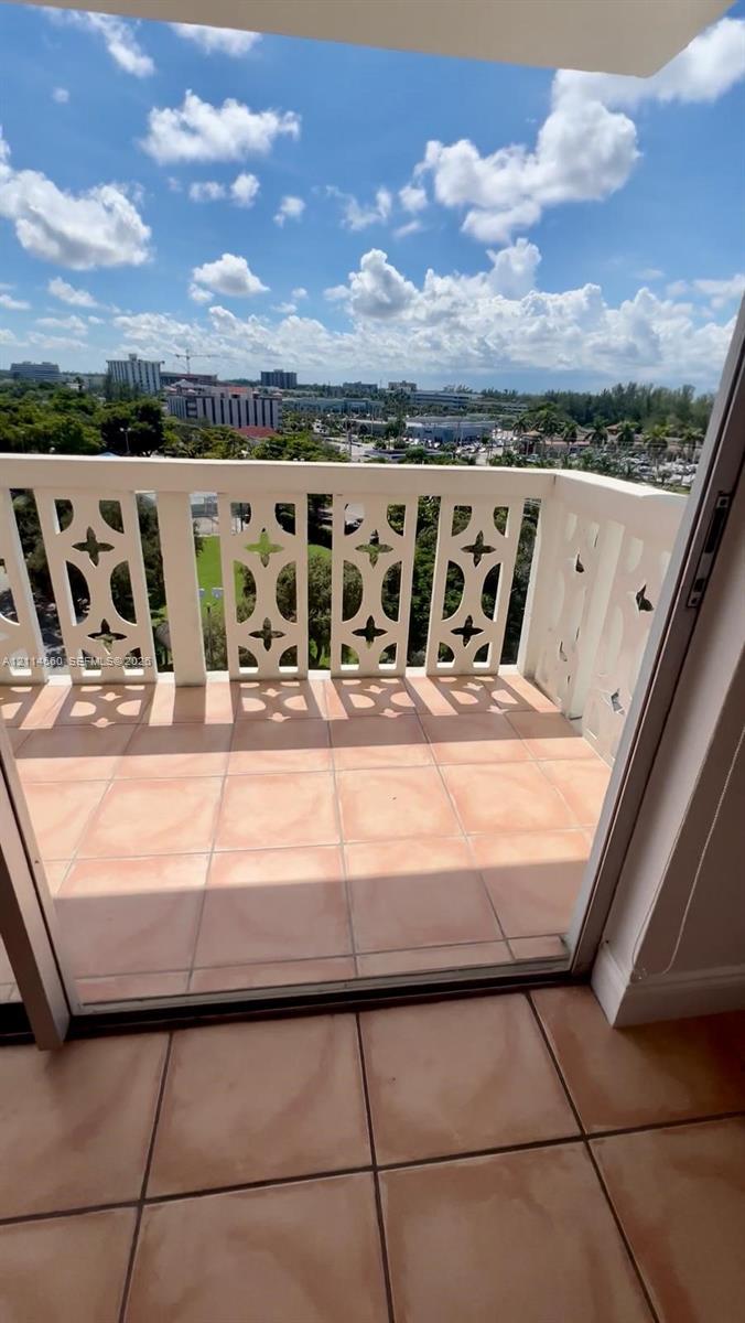 Private balcony featuring decorative geometric railing and tile flooring Private balcony featuring decorative geometric railing and tile flooring