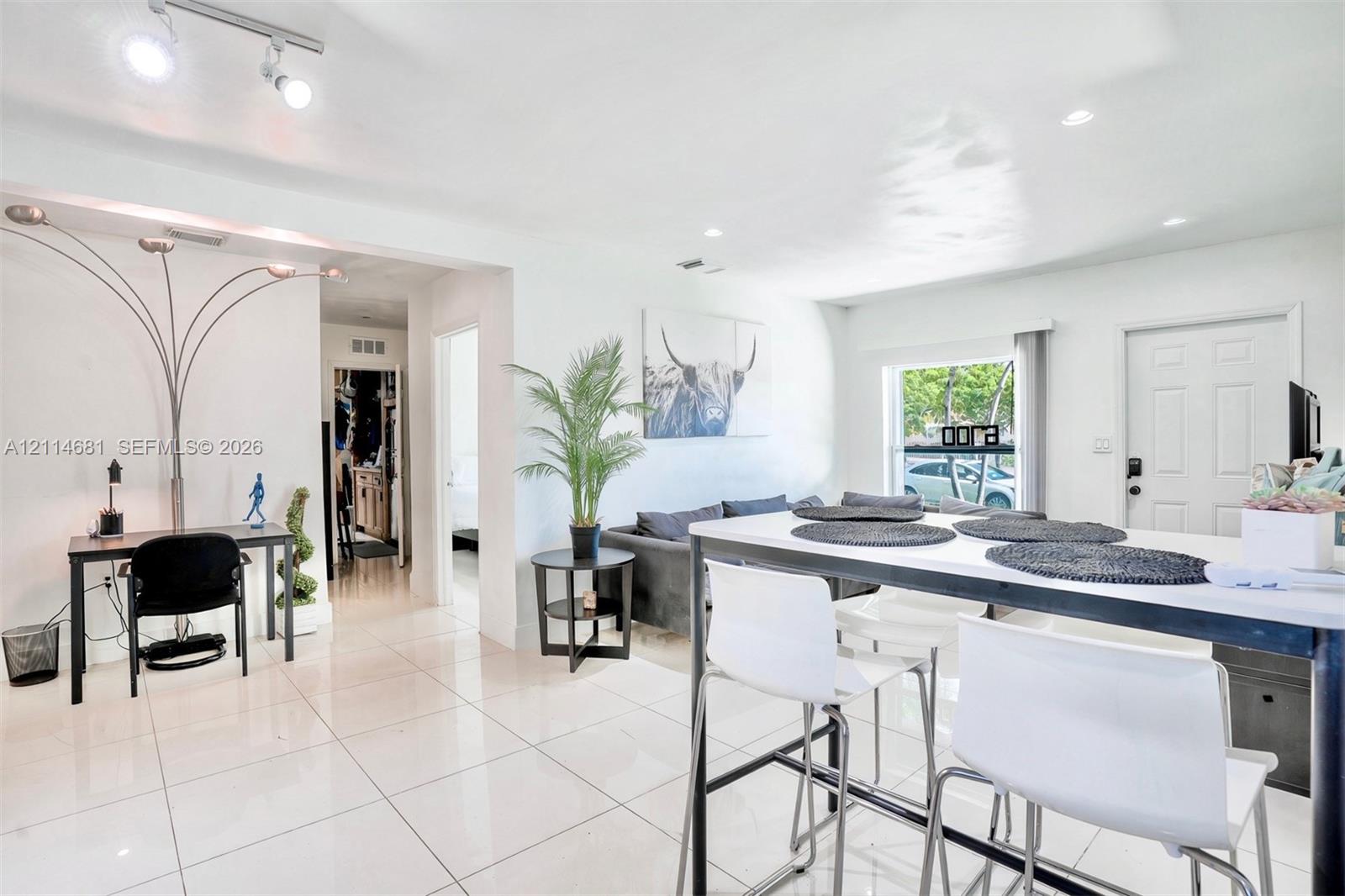 Open-concept interior featuring oversized tile flooring, recessed lighting, and multi-directional track lighting