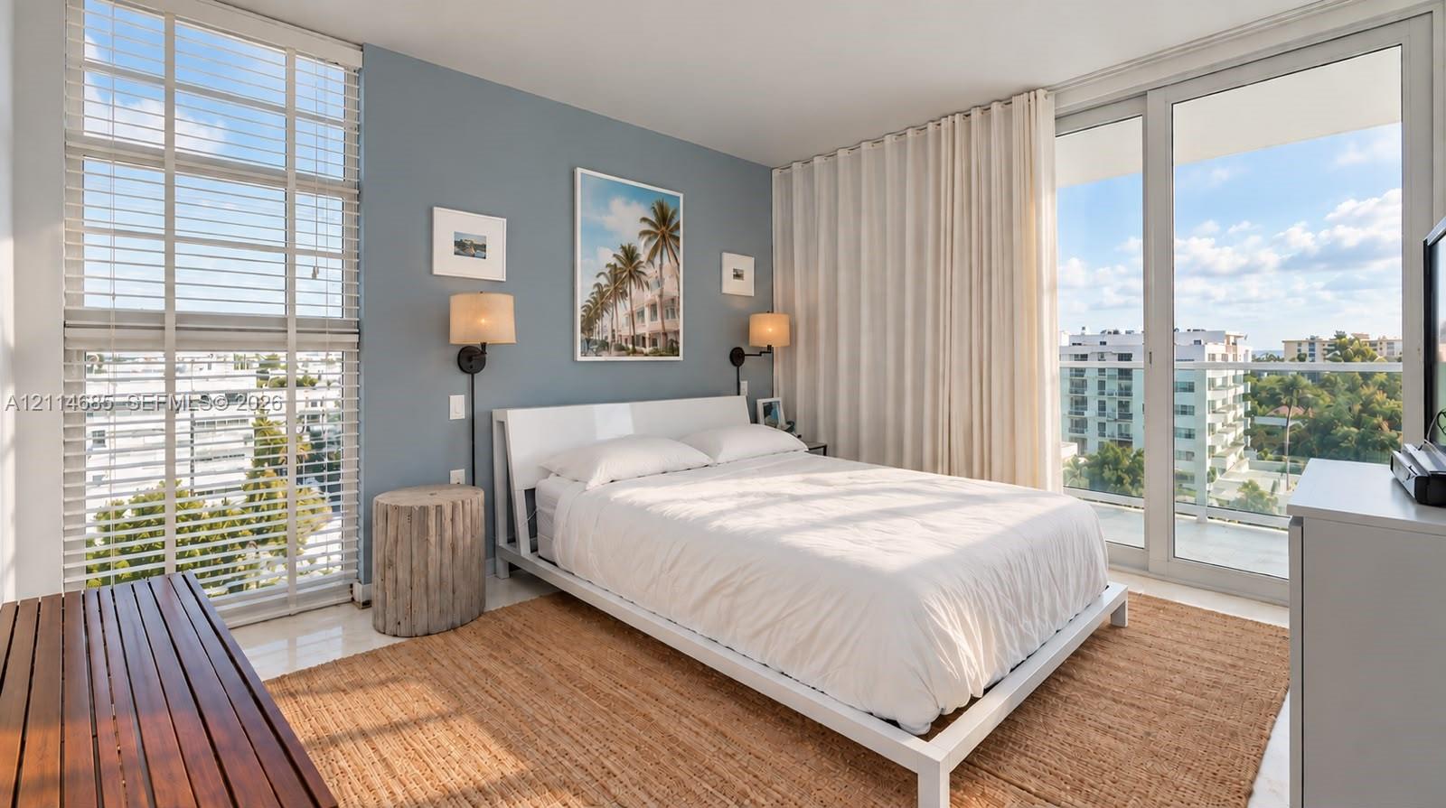 Floor-to-ceiling windows, sliding glass door with balcony access, and wall-mounted light fixtures