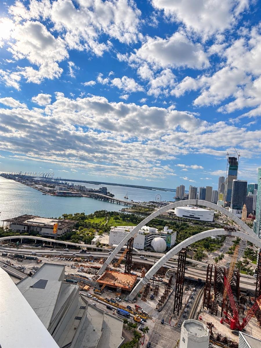 Elevated perspective showcasing coastal waters, cityscape, and urban infrastructure