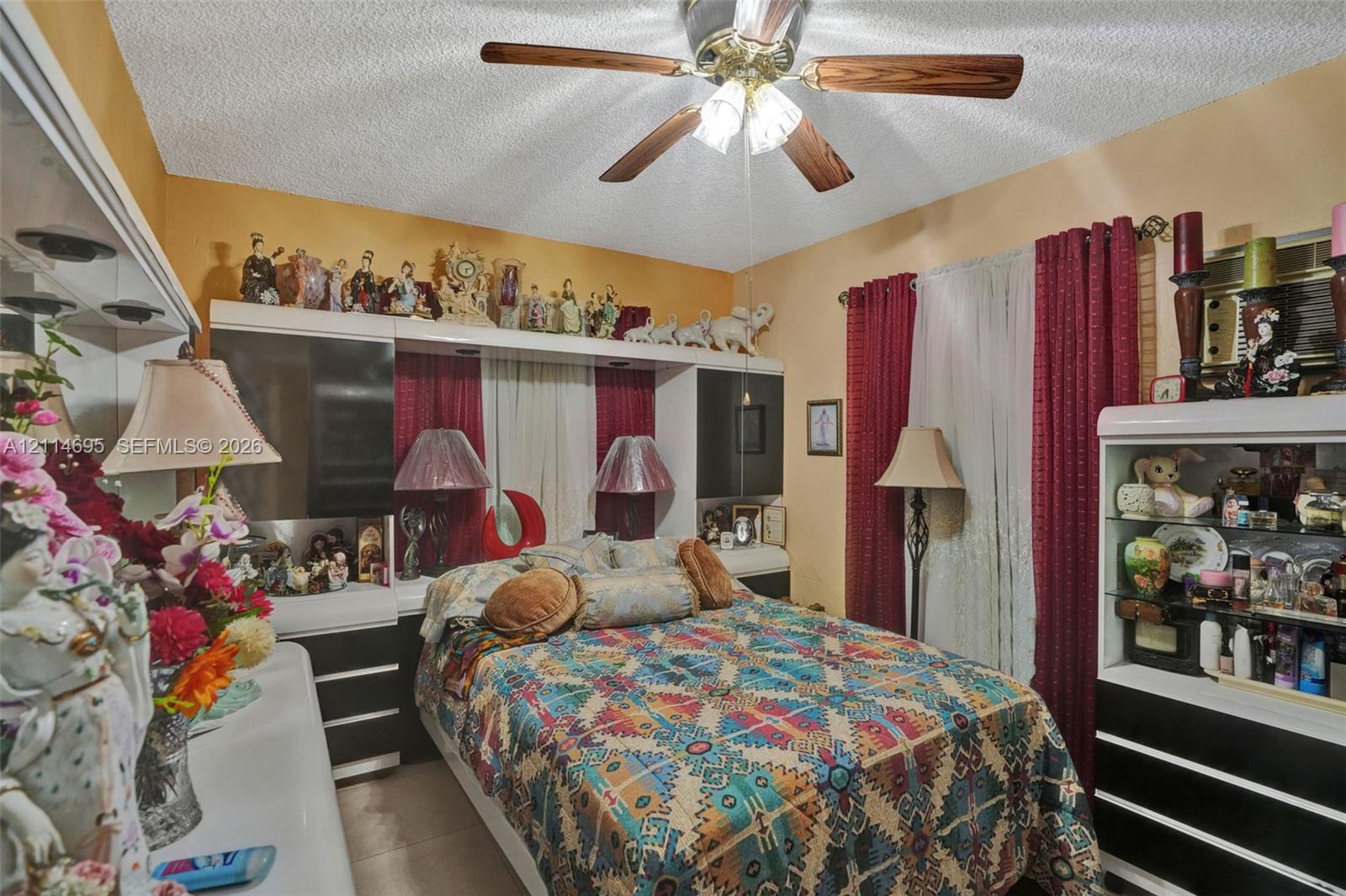 Built-in cabinetry featuring high-contrast finish, ceiling-mounted light fixture, and window treatments