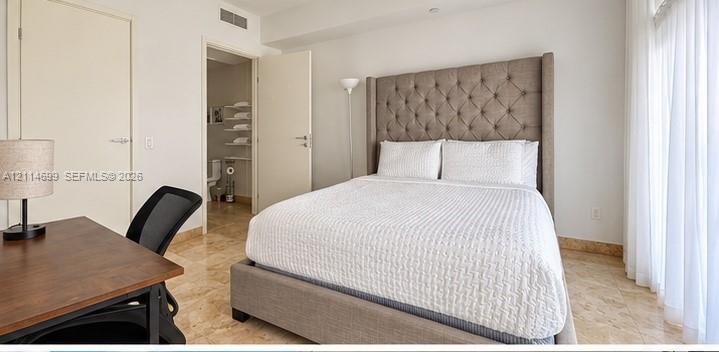 Stone-finish flooring and neutral-toned walls throughout