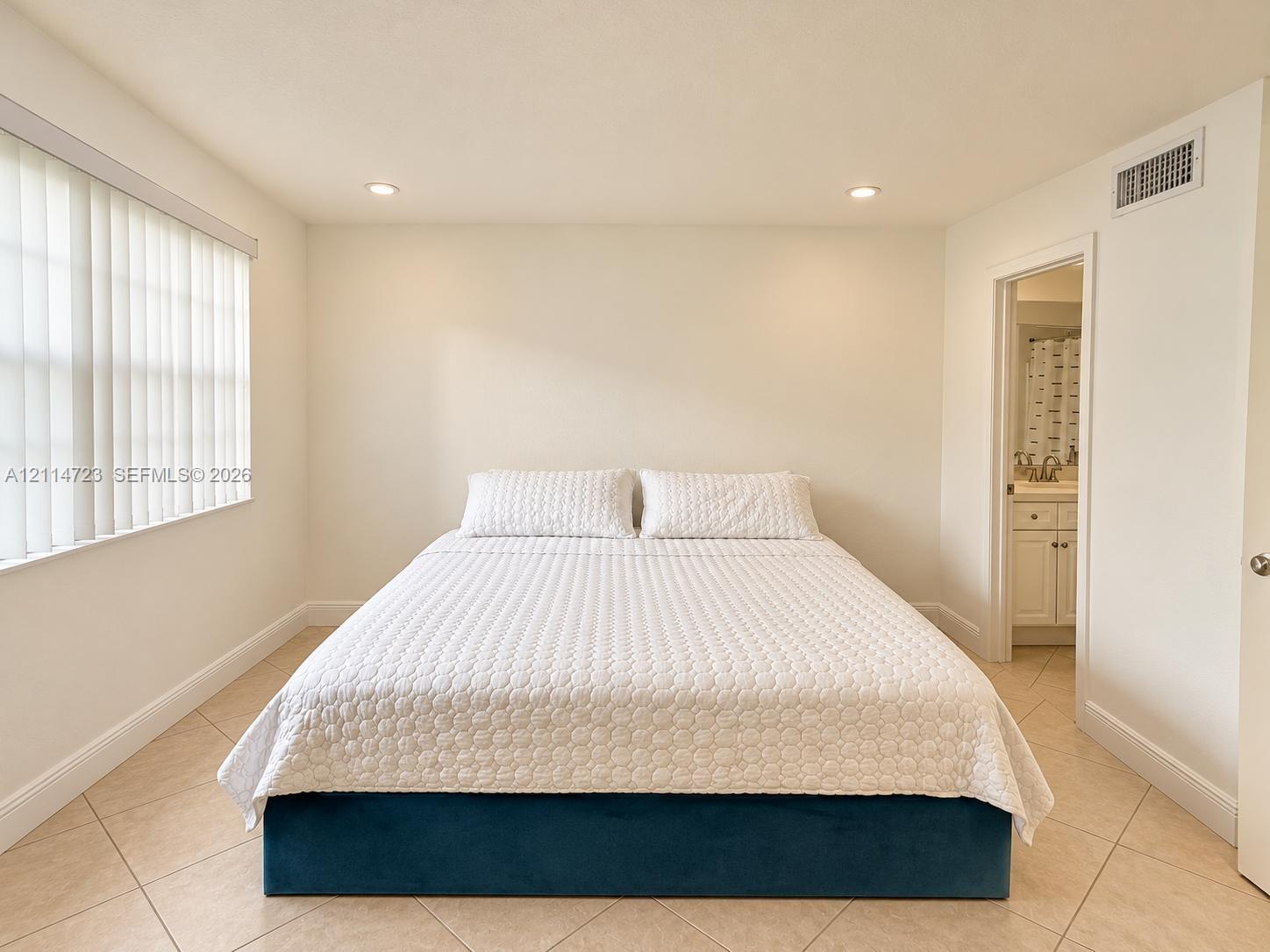 Room featuring diagonal ceramic tile flooring, recessed lighting, and vertical window blinds Room featuring diagonal ceramic tile flooring, recessed lighting, and vertical window blinds