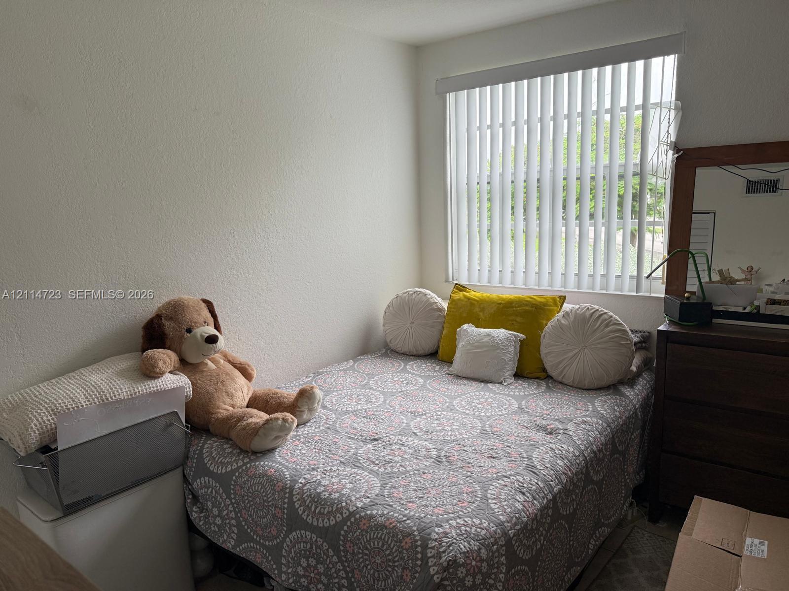 Neutral wall finishes paired with vertical window blinds Neutral wall finishes paired with vertical window blinds