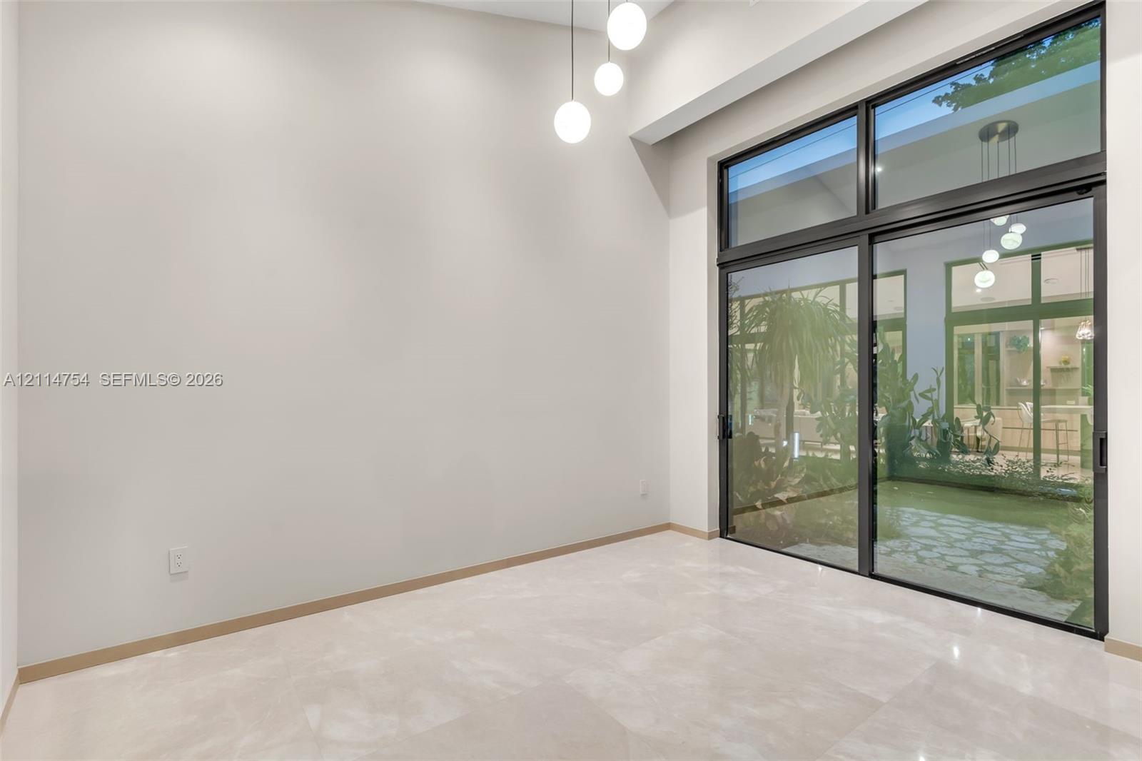 Vaulted ceilings with recessed lighting, stone-finish flooring, and minimalist wood-finish interior doors